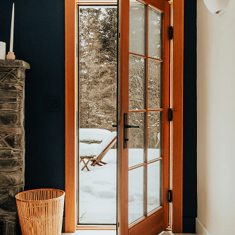 A door leading to a snowy outside framed with Douglas Fir lumber