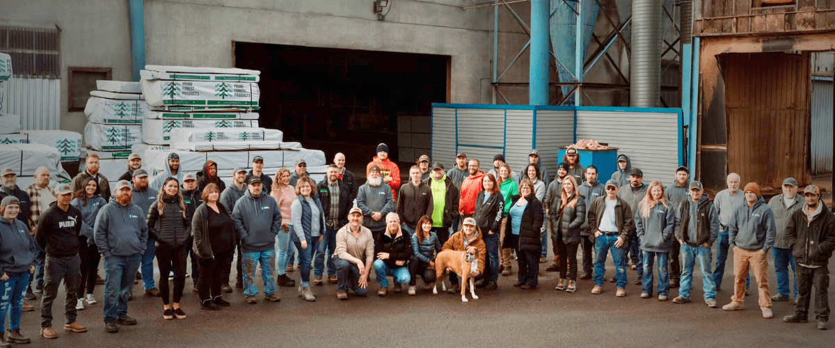Photo of the staff of Prime Forest Products in front of their remanufacturing facility