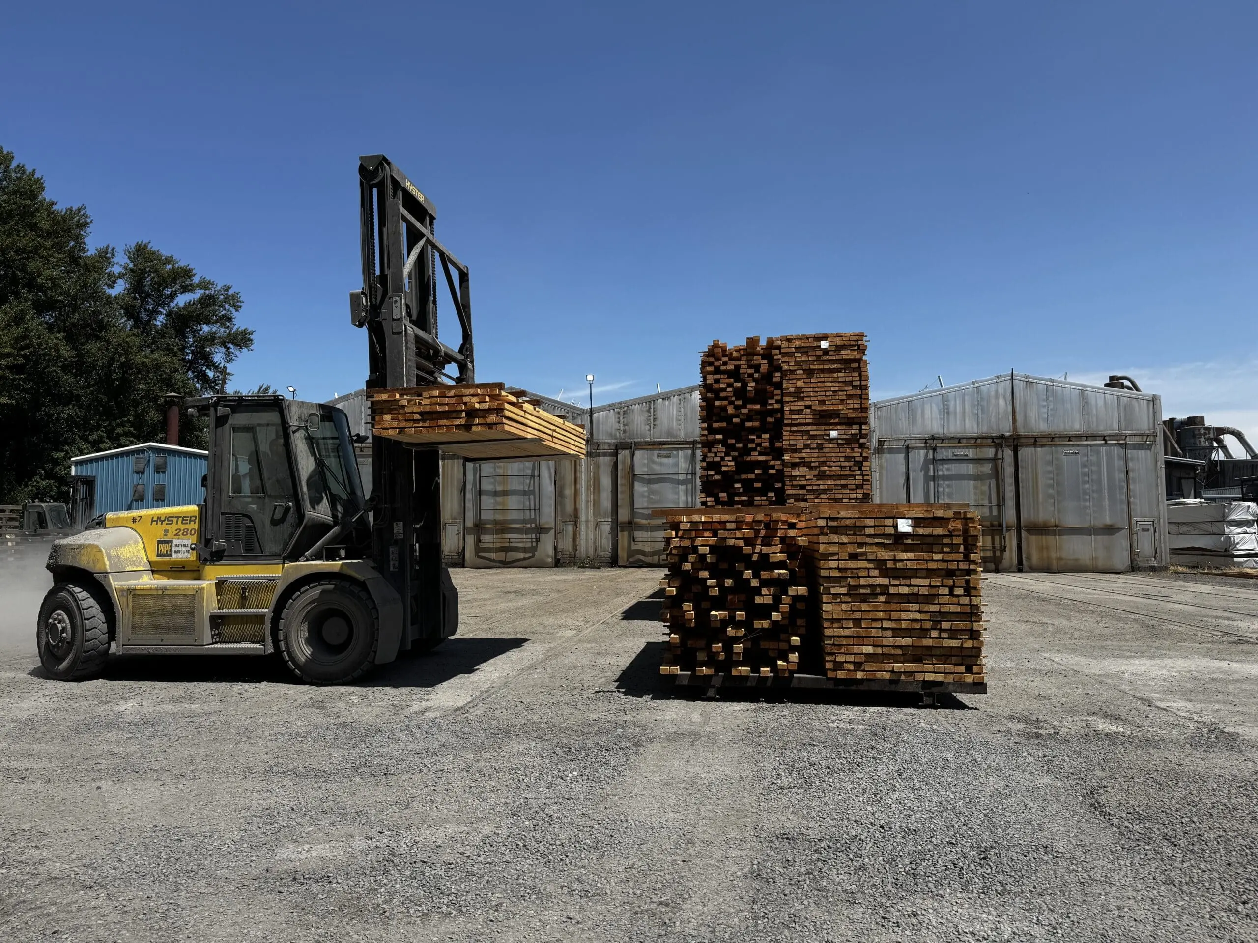 Forklift loading a stack of lumber that has been dried in a kiln